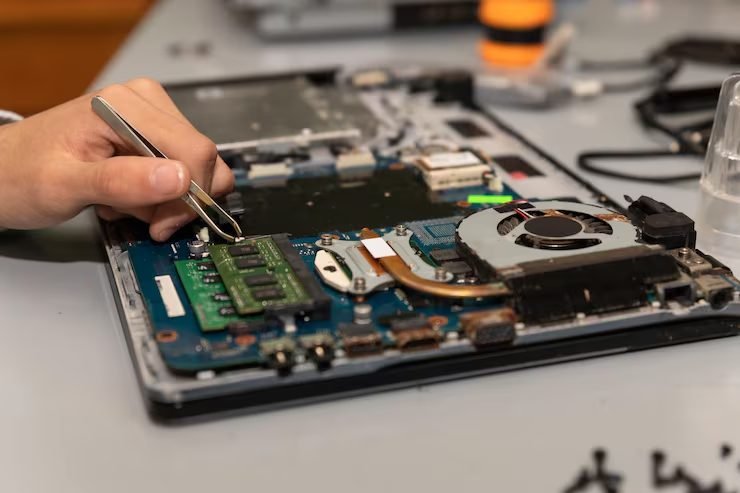 Technician repairing a laptop at FIXIT Mobile Care, Kuala Lumpur